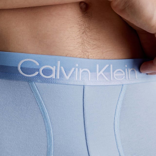 Mens Calvin Klein 3 Pack Trunks in blue.- Branded elasticated waistband.- Cotton stretch fabric.- Low rise.- Classic fit.- 95% Cotton  5% Elastane.- Ref: 000NB2970AMCAWaist: - S = 28-30in- M = 32-34in- L = 36-38in- XL = 40- 42in