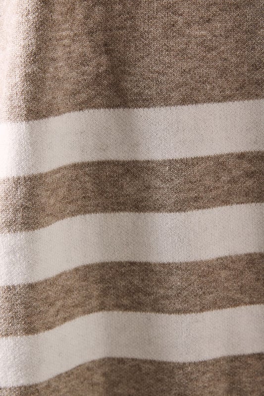 Chic striped roll neck poncho design
        Oversized, relaxed fit for ultimate comfort
        Elegant contrasting stripe pattern
        Long sleeves with dropped shoulders
        Versatile length suitable for various styling options
    
    Embrace sophistication and comfort with this striking striped roll neck poncho from Wallis. The oversized silhouette offers a relaxed fit, perfect for those who appreciate both style and ease. The elegant contrasting stripe pattern adds visual interest, while the long sleeves with dropped shoulders contribute to its laid-back charm. Ideal for casual events and family gatherings, this versatile piece can be styled effortlessly. Pair it with slim-fit trousers and ballet flats for a polished daytime look, or layer it over a fitted dress with ankle boots for a more refined ensemble. The poncho's adaptable length allows for various styling possibilities, making it a wardrobe staple for the fashion-forward woman who values both glamour and practicality in her everyday attire.