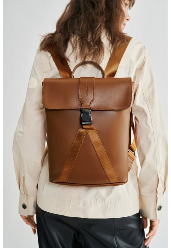 This contemporary style is perfect for those seeking practicality with style. Crafted with smooth leather, the bag oozes premium quality with a flap over front with gunmetal clip buckle and a leather grab handle. The premium nylon webbing shoulder straps are adjustable, providing comfort for the wearer as well as being durable. Inside reveals signature Smith & Canova lining and zip and fold pockets for any valuables. The exterior features a Smith & Canova debossed logo as well as an extra zip pocket. Features: , Smooth leather, Smith and Canova debossed logo, Flapover front with clip buckle fastening and nylon webbing, Gunmetal hardware, Leather grab handle, Adjustable premium nylon webbing shoulder straps, Smith and Canova signature lining, Internal zip and fold pockets, Padded 9 inch tablet slip pocket with Velcro tab fastening, External vertical zip pocket on the back, Smaller size Style Ref: 93056 TAN