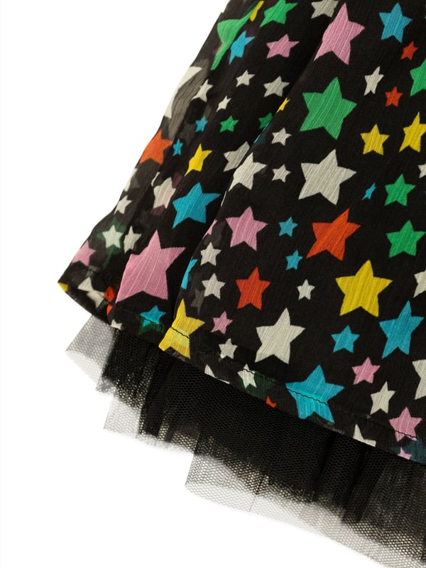 Introducing the Girls Star Skirt in Black by Stella McCartney, a quintessential piece for AW2024 that promises to adorn your girl's wardrobe with sophistication and flair. Masterfully crafted to capture the essence of youthful elegance, here‚  why it‚  indispensable: Stellar Design: Enriched with a chic star motif, perfect for making a fashionable statement.   Luxurious Comfort: Carefully constructed with premium fabrics that ensure all-day ease and contentment.   Versatile Charm: A perfect blend of glamour and practicality, easily paired with various styles.Elevate her ensemble with this dazzling skirt; a timeless treasure from Stella McCartney. Order now!