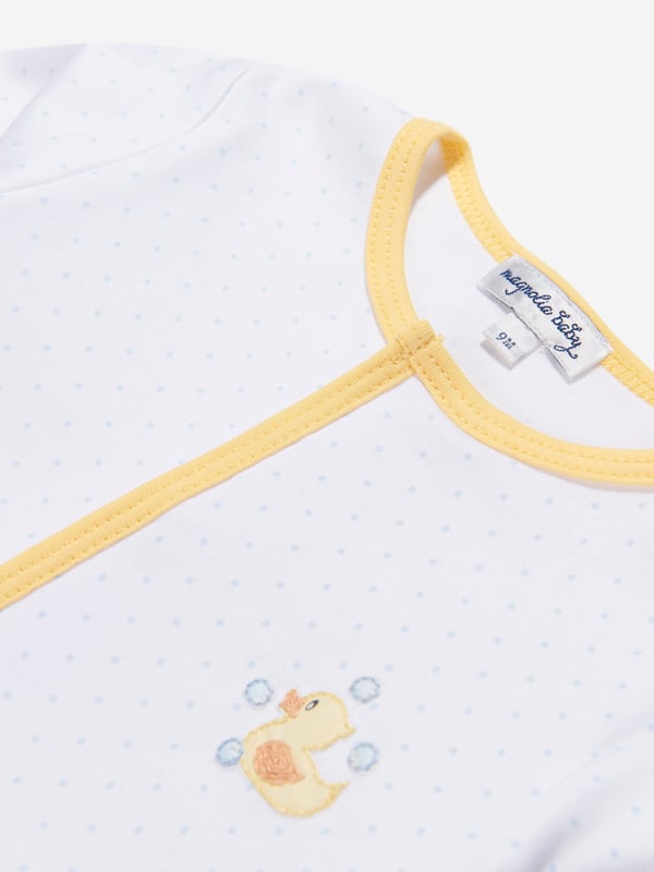 Introduce your little one to luxury with the Baby Rubber Ducky Embroidered Babygrow in White by Magnolia Baby. Crafted to delight both baby and parent, here are the essential features: Breathtaking Design: Adorned with a charmingly embroidered rubber ducky, the playful feature transforms this babygrow into a stylish statement piece. High-Quality Fabric: Made from the softest, premium grade organic cotton to ensure extraordinary comfort and breathability for your baby's sensitive skin. Unisex Appeal: Gracefully designed in a neutral white tone, it's an ideal addition to your baby boy's or girl's wardrobe. Ultimate Comfort: With easy snap fasteners, diaper changes become a breeze while ensuring your baby stays comfy and happy.Rediscover luxury for your baby, elevate their wardrobe with the Baby Rubber Ducky Embroidered Babygrow. Shop now to let your baby enjoy exceptional comfort in style!