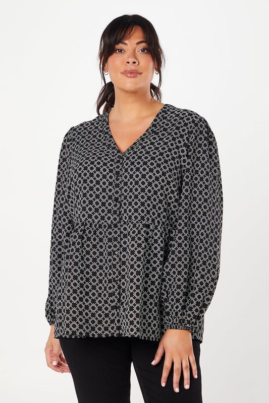 Striking geometric print for a modern, eye-catching look
        Button-through front design for easy wear and versatility
        Flattering peplum silhouette to accentuate the waist
        Voluminous long sleeves for a touch of drama
        V-neckline to elongate the neck and add a feminine touch
    
    This Dorothy Perkins peplum top radiates contemporary charm with its captivating geometric print. The button-through design offers both style and practicality, allowing for effortless dressing and the option to adjust your look. The peplum silhouette gracefully cinches at the waist before flaring out, creating a flattering shape for various body types. Style this versatile piece with slim-fit trousers and white trainers for a chic daytime ensemble perfect for brunching with friends or attending a casual family gathering. For a more polished look, pair it with dark tailored trousers and ballet flats, ideal for those days when you want to feel put-together without compromising on comfort. The long, billowy sleeves add a touch of drama, making this top a standout choice for your wardrobe that transitions seamlessly from day to night.