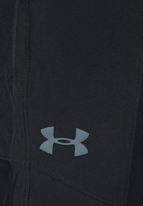 From the streets to the workout, rep these men's Vanish Track Pants from Under Armour. - - . These track pants are cut from smooth, durable poly fabric for lasting wear. - -. Comes In a Black and Grey colourway, they feature an elasticated waistband, with woven ankle cuffs to secure the fit. - -. Finished up with Under Armour branding around the cuffs, and a signature logo at the thigh. Machine washable. - -. Our model is 6'0" and wears medium size.