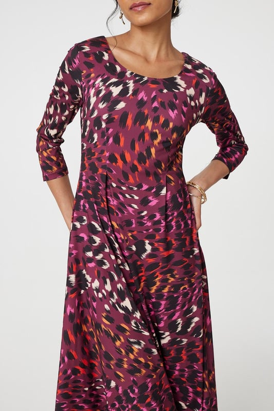 Add a vibrant animal print to your new season closet with this anima print midi dress. With a round neck, 3/4 sleeves, a hanky hem and a midi skirt. Style with strappy hees for a special event or pair with tights and block heeled boots to beat the chill.