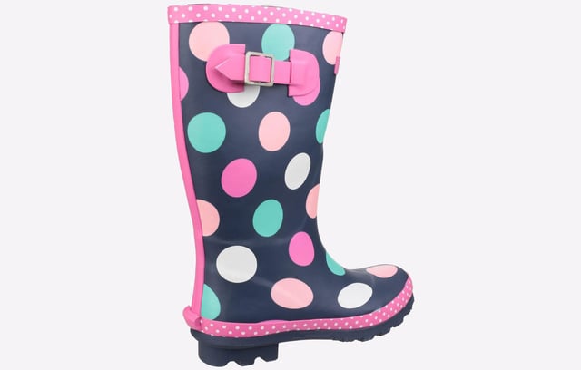 Perfect for the upcoming months, these Cotswold Dotty wellingtons are perfect for taking the rainy weather in stride and making a splash. The waterproof rubber upper is constructed in a classic wellington silhouette, with a deep navy colourway adorned with fun multi-coloured dots and a chic pink trim sure to brighten up your little ones day no matter what the weather. The slip-on design ensures easy on / off wear, with an adjustable buckle feature to the side for the perfect fit and feel. A soft textile lining and padded footbed provide comfort, with a durable rubber outsole and cleated heel for enhanced traction, making them a wardrobe essential for the upcoming months. 
 - Waterproof rubber outsole
 - Adjustable buckle feature
 - Textile lined with removable insole
 - Cushioned footbed
 - Slip on design
 - Rubber traction sole unit with chunky cleated heel
 - Cotswold branding
 *Do your bit for the environment as every pair of these Cotswold Shoes sold supports National Forest tree planting.*
 Please note: These boots come in a branded Cotswold bag and are not boxed.