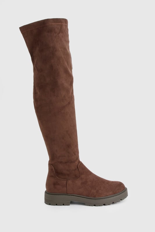 Knee-high boots with chunky silhouette
        Faux suede upper for a luxe look
        Flat heel (0-2cm) for all-day comfort
        Robust cleated sole for enhanced grip
        Side zip closure for easy on-and-off
    
    Make a bold statement with these eye-catching knee-high boots from Boohoo. The chunky silhouette and faux suede finish create a striking look that's perfect for the fashion-forward trendsetter. Designed with comfort in mind, the flat heel allows for effortless all-day wear, while the cleated sole provides excellent traction on various surfaces. Style these versatile boots with a flowy midi dress and oversized jumper for a chic autumn ensemble, or pair them with skinny jeans and a leather jacket for an edgy night-out look. Whether you're heading to a casual family gathering or a day out with friends, these boots will keep you on-trend and comfortable from dawn to dusk.