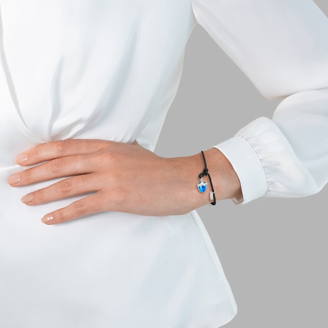 GENERAL INFORMATION:  • Bracelet type: Textile Bracelet  • Clasp/closure/buckle: Pull clasp  • Targetgroup: Female  MATERIAL:  • Basematerial: Stainless steel  • Color Basematerial: Silver  • Further material 1: Textile  • Surface Treatment: High-gloss polished  DIMENSIONS:  • Pendant height mm, approx.: 12,8  • Pendant width mm, approx.: 8,9  • Bracelet width mm, approx.: 1,6  • Bracelet length cm, approx.: 16,0 - 21,0 cm, adjustable  STONES:  • Stone type 1: Glass  • Stone color 1: Blue  • Stone type 2: Preciosa  • Stone color 2: White  • Stone cut 2: Facetted
