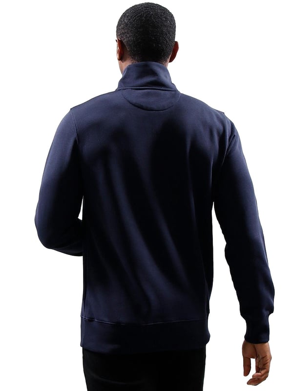 This versatile half-zip sweatshirt combines comfort and style with a premium cotton-polyester blend that's perfect for transitional weather. Featuring a small, intricately embroidered GANT graphic on the chest, it showcases a subtle yet elevated design. The ribbed hem and cuffs create a tailored silhouette. Designed for a regular fit, the half-zip collar adds a touch of sporty elegance, while the durable fabric ensures long-lasting wear.