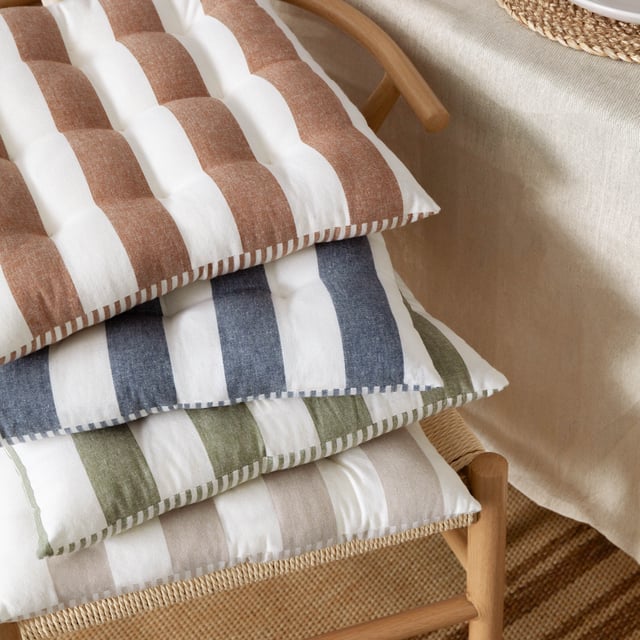 Elevate your seating with the Hayle Striped Cotton Seat Pads, crafted from 100% cotton and designed to bring comfort and style to your living space. Perfect for both indoor and outdoor use, these pre-filled seat pads feature a soft yet durable finish with calming stripe patterns on each side, adding versatility and a timeless aesthetic. The addition of secure tie fastenings ensures they stay neatly in place, while the plush filling provides exceptional support. Whether enhancing your garden furniture or bringing a relaxed, modern edge to your dining room, these seat pads effortlessly combine style with functionality.