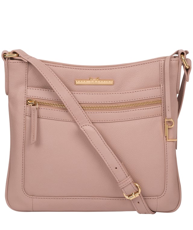 The 'Lewes' cross body bag from Pure Luxuries London, is crafted from naturally milled leather with a beautifully distinct fine-grain feel. A zip-over top secures a gorgeous, 100% natural cotton-lined interior with two slip pockets. On-the-go storage comes in the form of an exterior zipped pocket and two slip pockets, complemented by an adjustable and matching leather shoulder strap. Furnished with gold coloured metal fittings and the elegant Pure Luxuries London charm and logo plate.