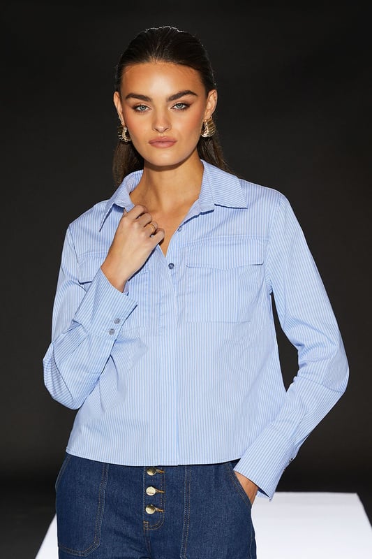Cropped boxy silhouette for a contemporary edge
        Utility-inspired design with functional chest pockets
        Crisp poplin fabric for a polished look
        Versatile collared neckline
        Part of the exclusive RUNWAY 1.8.1.8 collection
    
    Embrace effortless chic with this Runway 1.8.1.8 Stripe Poplin Cropped Boxy Utility Shirt. The cropped length and boxy fit create a modern silhouette that's perfect for the fashion-forward woman. Style this versatile piece for a range of casual occasions - pair it with high-waisted jeans and trainers for a relaxed weekend look, or tuck it into a midi skirt with ankle boots for a smart-casual ensemble. The utility-inspired design, complete with practical chest pockets, adds a touch of functionality to your wardrobe. Whether you're heading to a family gathering or meeting friends for brunch, this shirt will keep you looking stylish and feeling confident. The crisp poplin fabric ensures a neat appearance throughout the day, making it an ideal choice for those who appreciate both comfort and style in their daywear.