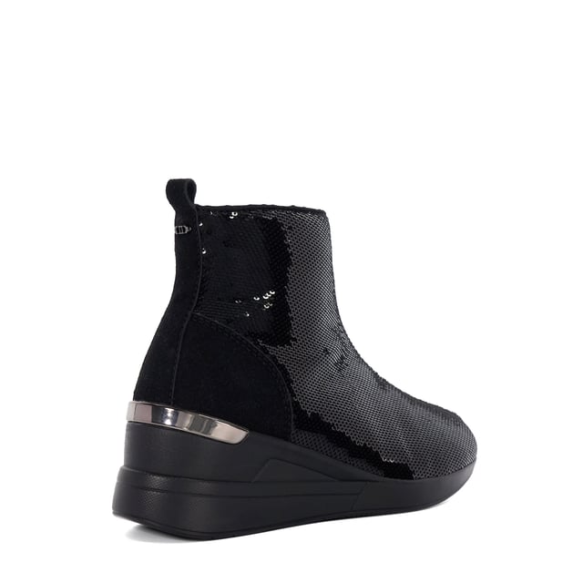 Make a style statement in Effecting, an ankle boot with a twist. Designed with a dazzling sequin finish and a chic chunky wedge heel, this design is perfect for adding glamour and flair to any ensemble, whether you're hitting the town or elevating your everyday look.