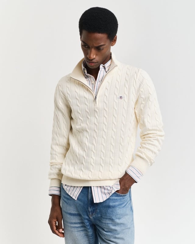 Designed in cotton with an all-over cable knit structure, this soft sweater has a regular fit and sporty half-zip collar. A preppy essential, it is detailed with our iconic GANT shield embroidered at the chest, and ribbed endings at the neck, hem and cuffs.
Regular fitHalf-zip collarCable knit structureGANT graphic embroidered at chest
 
100% Cotton
 