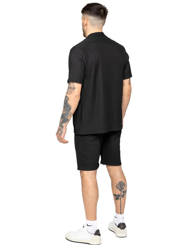 Elevate your summer style with our Enzo Milano Men's Outfit Set, including a textured ribbed revere shirt and relaxed fit shorts. Experience ultimate comfort with a button fastening and adjustable drawstring waistband, while looking effortlessly stylish with a revere collar and single back welt pocket. Made with premium fabric, this set is perfect for any occasion.