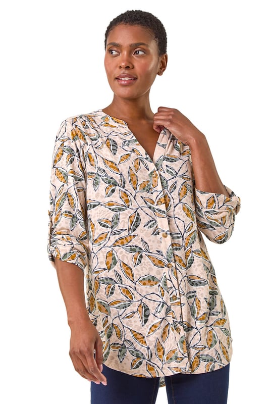 Button Detail Leaf Print Blouse from Roman. Stand out this Autumn in this charming leaf print blouse. Featuring a striking all-over leaf design, this blouse comes complete with a sophisticated button-through centre front for easy wear. The addition of tabs on the sleeves adds a touch of casual chic to this statement piece. Pair with your favourite jeans and trainers for a stylish and trendy look that will take you from day to night effortlessly.
