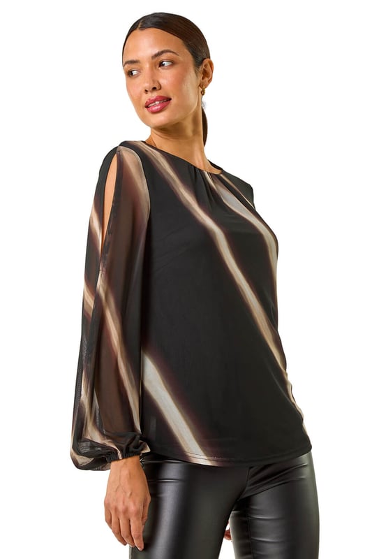 Stripe Print Mesh Overlay Top from Roman. Add a touch of elegance to your Autumn/Winter wardrobe with this chic mesh overlay top featuring an all over stripe print. With long sleeves and an elasticated cuff, this piece is designed with a classic round neck and falls to a flattering hip length. Perfect for layering over a camisole or fitted top, pair with tailored trousers and heels for a sophisticated look that transitions seamlessly from day to night!