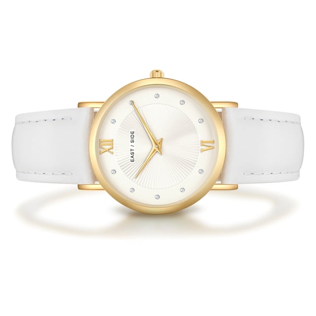 GENERAL INFORMATION:  • Targetgroup: Female  • Wristwatch: No Special Functions  • Display: analogue  • Weight of watch w/o box (gr.) - approx.: 27,0  MOVEMENT:  • Movement: Quartz  • Term of Movement: 2025  • Origin of movement: Japan  BRACELET:  • Material of bracelet/strap: Genuine leather  • Plating of bracelet/strap: None  • Finishing of bracelet/strap: Smooth  • Finishing/Decoration of bracelet/strap: Seam  • Clasp/Closure/Buckle: Buckle  • Color of bracelet/strap: White  • Length of bracelet/strap (mm) approx.: 210,0  • Width of bracelet/strap (mm) approx.: 18,0  • Style/Design of bracelet/strap: No imprint  • Bracelet/strap adjustable?: No  CASE:  • Shape of case: Round  • Size/Diameter of case in mm . approx.: 33,0  • Height of case in mm: 6,7  • Case material: Metal (Alloy)  • Surface of case: Polished  • Bezel/Topring: Fixed  • Finishing/Decoration of case: None  • Material of case back: Stainless steel  • Lock of case back: No screwed-in crown  • Color of case: Yellowgold  • Coating/Plating (Case): Ion-Plating (IP)  • Type/Form of crystal: Flat  • Material of crystal: Mineral crystal  • Water resistant (ATM): 3  DIAL:  • Size jewelry care cloth: Hour, Minute  • Indices: Roman numerals/points  • Material of dial: Brass  • Structure/pattern of dial: sunray  • Color of dial: White  PUSHER, CROWN, HAND:  • Pusher: None  • Corrector: No  • Crown: No screwed-in crown  • Type of hands: Dauphine hands  • Luminescent (hands): No  PACKAGING & SCOPE OF DELIVERY:  • Box: Yes  • Service booklet: Yes  • Manual: Yes
