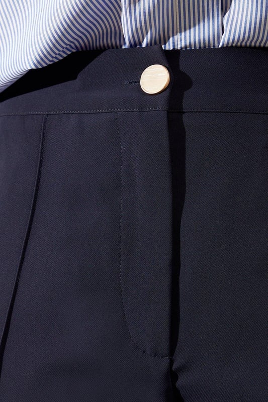 Tapered fit for a sleek silhouette
        Elegant split hem detail
        High-waisted design for a flattering fit
        Versatile style suitable for smart and casual occasions
        Comfortable stretch fabric for all-day wear
    
    These split hem tapered trousers from Wallis are the epitome of sophisticated style with a modern twist. The tapered fit creates a streamlined look that flatters your figure, while the split hem adds a touch of contemporary flair. Perfect for the woman who values both comfort and elegance, these trousers can effortlessly transition from day to night. Pair them with a crisp button-down shirt and blazer for a polished office ensemble, or dress them down with a silk blouse and statement jewellery for evening drinks. The high-waisted design not only accentuates your waistline but also provides a smooth foundation for tucked-in tops. Whether you're attending a formal event or aiming for a smart-casual look, these versatile trousers will ensure you always look put-together and feel confident.