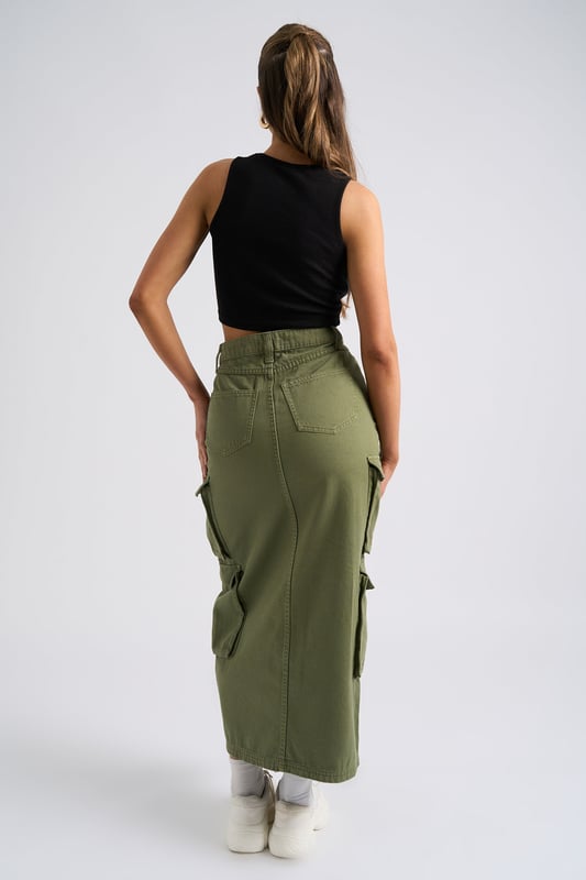 Model is 5'6 and wears a size S. Slim fit. High Waisted. Midi length. Introducing our Khaki Soda Cargo Skirt, a versatile and stylish addition to your wardrobe that effortlessly combines functionality with fashion-forward design. Crafted with attention to detail and quality, this skirt is perfect for those who seek comfort without compromising on style.