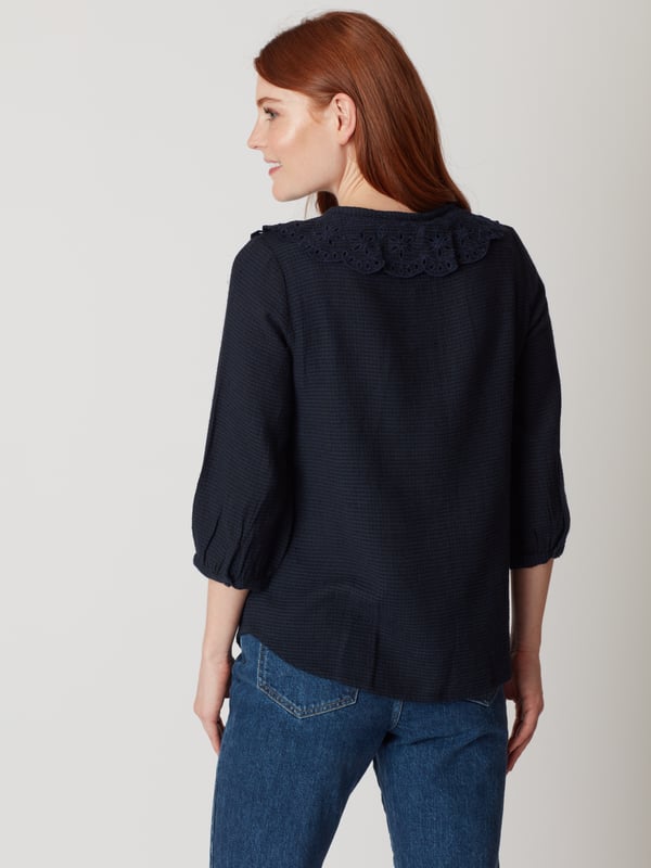 Discover the classic elegance of the Gale Collar Blouse, perfect for elevating your everyday style. Crafted from a soft cotton blend, featuring a textured weave and exquisite embroidered collar, this navy blouse is ideal for day-to-evening wear.