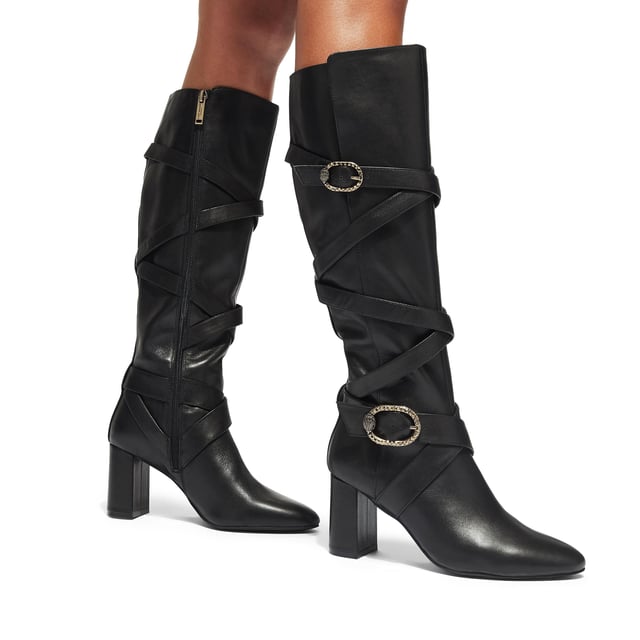 This Kurt Geiger Mayfair Strappy Knee high boot is crafted from a soft black leather with  strap detail up the entire shaft. There are two antiqued brass buckles with eagle heads across the straps. Heel height: 8cm.