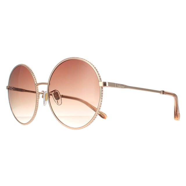Chopard Round Womens Shiny Copper Gold Brown Gradient  SCHF11V  Sunglasses are a elegant round style crafted from lightweight metal. Silicone nose pads and plastic tips provide all day comfort. Slender temples feature the Chopard logo for authenticity.