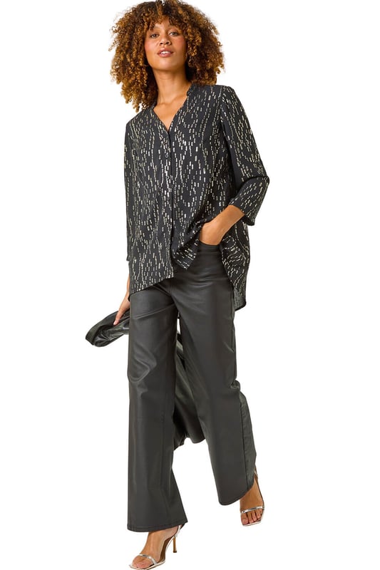 Dotted Foil Blouse from Roman. Sparkle and shine in this stunning dotted foil blouse, perfect for the Autumn/Winter season. The V-Neckline and long sleeves with cuff detail add a touch of elegance, while the mini frill detail around the neckline brings a fun element to this blouse. The foiled fabric gives a glamorous twist to the classic blouse style. Pair it with jeans and heeled boots for a chic and stylish look that will turn heads wherever you go!