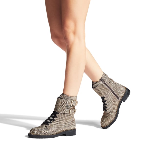 The Sutton ankle boot arrives in a beige houndstooth fabric topped with gold crystal embellishment. The front is laced up with two gold tone buckled ankle straps. Heel height: 3cm.