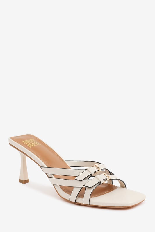 Step up your style with these Torigh Cross Over Buckle Details Strap Heel. Perfect for casual outings or dressy events, these sandals combine modern elegance with lasting comfort, making them a must-have addition to your wardrobe.

Key Features: 
Durable Construction: Crafted with high-quality faux leather, these sandals are designed to last. The sturdy heel and durable straps provide reliable support, ensuring they can withstand regular wear without compromising style.
Chic Design: The multi-strap design with subtle metallic accents exudes elegance and sophistication. The square toe and slender heel add a modern, fashion-forward touch that enhances their timeless appeal.
Comfortable Fit: Featuring a padded insole and a balanced heel height, these sandals provide all-day comfort without sacrificing style. The open design ensures breathability and ease of wear, making them perfect for any occasion.

Specifications:
o   Material: High-quality faux leather
o   Heel Type: Slender heel
o   Closure: Slip-on design for convenience

Elevate your footwear collection with these Torigh Cross Over Buckle Details Strap Heel. Combining chic design, durable construction, and superior comfort, they are perfect for making a statement wherever you go!