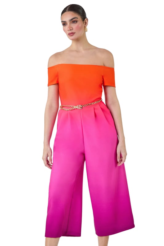 A-Ombre Bardot JSuit from Roman. Elevate your occasionwear this Summer with a vibrant ombre print jumpsuit! The perfect alternative to an occasion dress, this jumpsuit is cut in a flattering wide leg shape with culotte trousers and handy side pockets. Cinched in with a detachable metal belt, this ombre style has a striking gradient design and an even more flattering bardot neckline. Finishing off the shoulder with short sleeves, this stretch style has pleat details at the waist to create a feminine flow. Style yours with strappy heels for your next Summer event!
