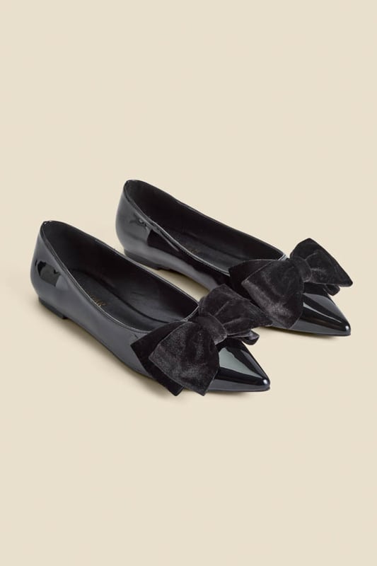 Who needs heels?Luxe patent leather for a hi-shine finish Adorned with a plush velvet bow Wear-forever pointed toe silhouette Flat sole so you can dance the night away We're styling them with wide-leg trousers and a sparkly top