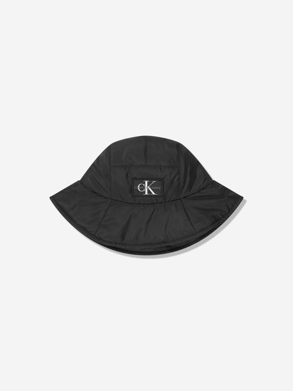 Introducing the Kids Quilted Bucket Hat in Black by Calvin Klein Jeans‚ the perfect accessory for your unisex wardrobe this Summer. Here are the key features of this exquisite piece:‚Classic Design: Made to shield your little ones from the sun with style, its quilted design offers a chic and modern look.‚ Premium Quality: Sourced with top-notch materials, ensuring uncompromised comfort and durability for your child's everyday use.‚ Versatile: Adapts perfectly with any outfit‚be it at the beach or during a casual city-walk. A Black bucket hat never goes out of style!‚ Signature Brand: Designed by Calvin Klein Jeans, this bucket hat epitomizes premium fashion in every stitch. Don't wait! Let your child flaunt the timeless style of Calvin Klein with our Kids Quilted Bucket Hat in Black.