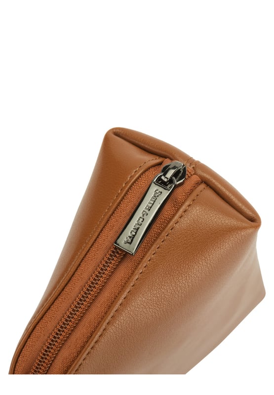 This staple zip around cosmetic bag in genuine leather, inside features a zip pocket, elasticated pocket and elasticated cosmetic holders. This minimal design includes a debossed logo and gunmetal zip pull. Features: , Zip around fastening, Smith & Canova debossed logo, Smith & Canova branded interior, Inner zip pocket, Elasticated pocket, Genuine Leather Style Ref: 26833 TAN