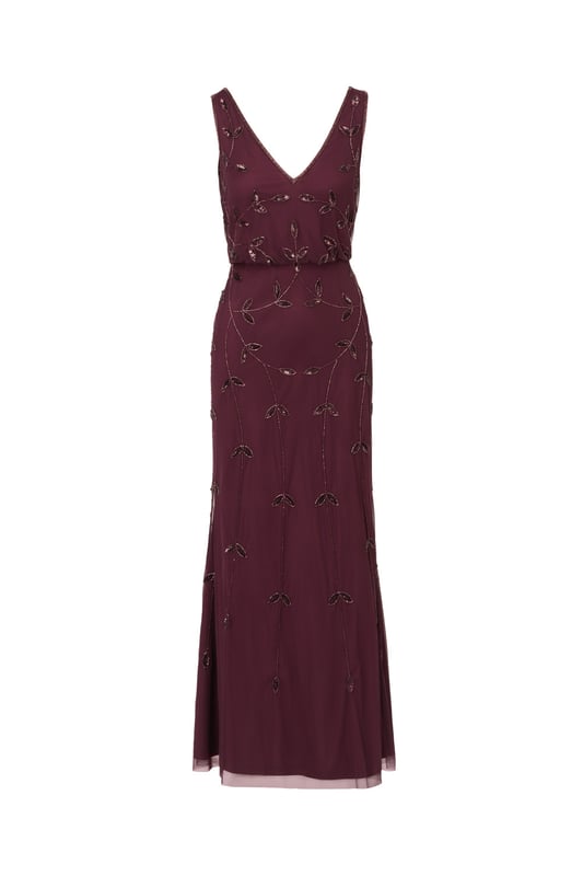 Put a little sparkle on display when you rock this sleeveless blouson gown. This formal dress features a sleeveless blouson bodice, deep v-neckline and back, and a soft skirt. Crafted with a luxe mesh fabric that is fully lined, this evening gown is embellished with sequin and beaded vines. The neckline and armholes of this gown are trimmed in beading for added sparkle. A hidden zipper closure at the centre back completes the design. This sleeveless beaded gown is a stunning look for a wedding guest or bridal party and pairs well with neutral or metallic accessories.