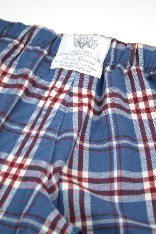 Unisex Lounge pant Pyjama Trouser in Mid blue, Red and White woven check design. 100% Cotton soft brushed woven check fabric. Elastic waist and side pockets. Jersey inner waistband for comfort and an extra drawcord. machine washable. wear them with your favourite T-shirt for that perfect lounge wear outfit.
