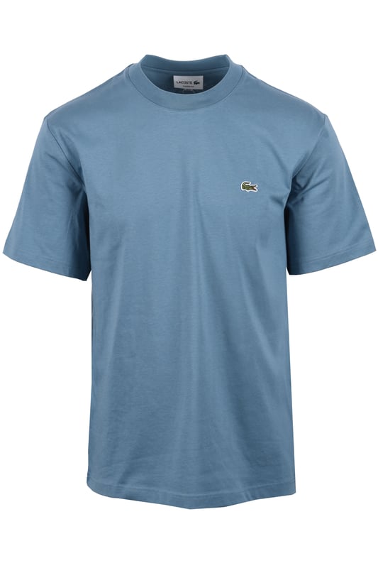 Lacoste Tee in Limestone
Experience the difference with the Lacoste Limestone Tee, a testament to Lacoste's legacy of sportswear excellence since 1933. Crafted from premium Peruvian Pima cotton, this essential tee offers superior comfort and durability. The exceptionally fine, lightweight fabric boasts a subtle sheen and a robust construction, making it a wardrobe staple you can rely on.
 
Features

Premium Pima Cotton: Experience the luxurious feel of 100% Peruvian Pima cotton, known for its superior softness and durability.
Lightweight Fabric: The 130 GSM fabric provides breathability and comfort for all-day wear.
Classic Fit: A regular, straight cut offers a timeless silhouette that looks great on everyone.  Please note: If you are between sizes, we recommend ordering one size up for a more comfortable fit.   
Iconic Branding: The embroidered crocodile on the chest adds a touch of signature Lacoste style.   
Versatile Style
Style code: TH7318