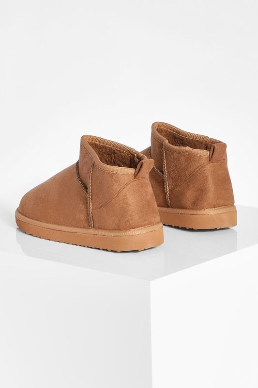 Ultra mini design for a contemporary twist on classic boot styles
        Flat heel between 0 and 2cm for all-day comfort
        Synthetic suede upper for a soft, luxurious feel
        Slip-on style for effortless wear
        Versatile silhouette suitable for various casual occasions
    
    Step into style with these ultra mini shoe boots, a must-have addition to your casual footwear collection. The sleek, low-profile design offers a modern take on traditional boot styles, perfect for the fashion-forward individual. Pair them with cropped jeans and an oversized jumper for a relaxed weekend look, or team with a flowy midi dress for a chic daytime ensemble. The flat heel ensures comfort for extended wear, making these boots ideal for family gatherings, shopping trips, or casual outings with friends. Their versatility allows for seamless transition from day to night, offering endless styling possibilities for the contemporary British fashionista. Embrace the latest trends while prioritising comfort with these ultra mini shoe boots, a true embodiment of Boohoo's commitment to accessible, on-trend fashion.