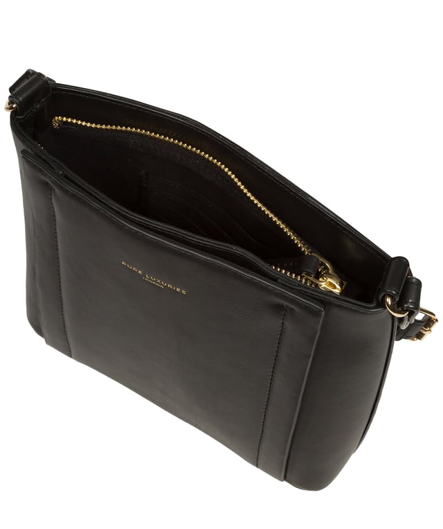 The 'Kali' cross body bag from Pure Luxuries London's Knightsbridge Collection is handcrafted from gold standard Nappa leather with a super-soft and smooth finish. The zip-over top opens to reveal a 100% cotton interior. The spacious compartment features four card slots to help maintain an organised bag. A slip pocket on the front of the bag provides on-the-go storage. Features gold-coloured metal fittings and zips alongside the adjustable slim leather strap with a maximum drop length of 65cm. The Pure Luxuries logo is embossed in gold foil for a beautifully simple finishing touch.