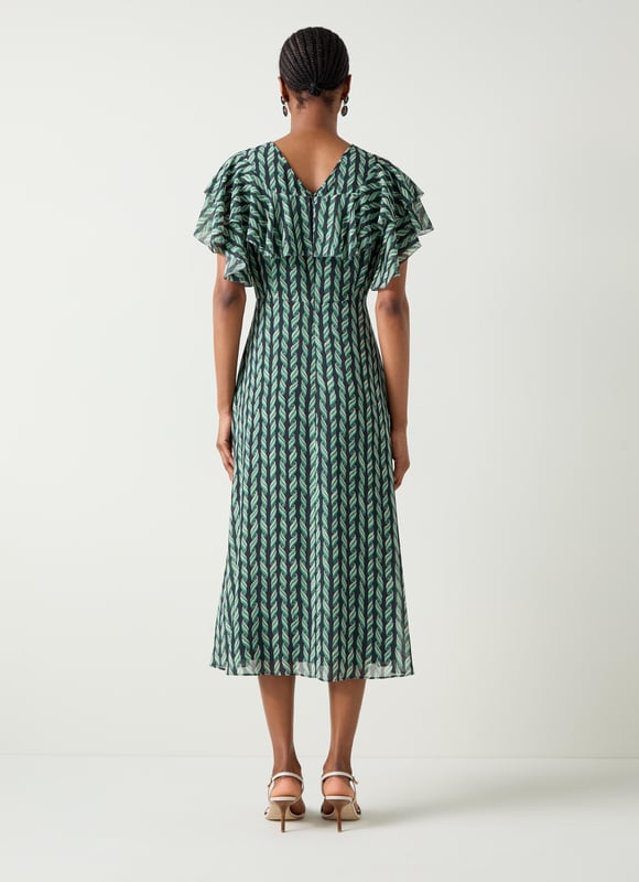 Embrace elegance with the Agnes ribbon print georgette frill dress. This beautifully crafted piece is adorned with picot edging, a convenient zip closure, a scoop neck, and full length sleeves. Perfect for evening occasions, complement it with heels and a clutch or ballet flats for a sophisticated, relaxed look.
