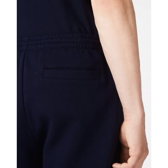 PRODUCT REF. GH9627-00 Efficient. Durable. Comfortable. An iconic, performance-enhancing essential that's comfortable enough to relax in. Regular fit, straight cut: Unrestricted freedom of movement. Drawstring waist: An adjustable waistband for optimum comfort. Back pocket with piping: Practical and functional. Embroidered crocodile on the front: Lacoste-typical performance. Brushed organic cotton fleece: Long-lasting comfort during sports. Main material: cotton (84%), polyester (16%) / pocket lining: cotton (100%)