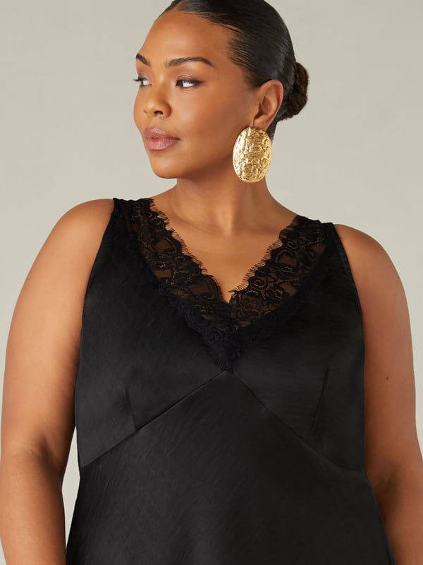In classic black, this cami is made from the softest of satins and cut on the bias for a flattering fit. With an elegant lace neckline, it has bust seam detailing and flattering darts which create a cinched in silhouette. Its floaty, effortless shape and versatile design make this the perfect top for an evening out.