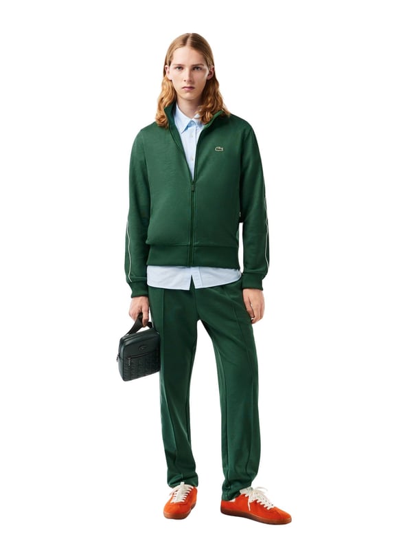This regular-fit men's sweat jacket with contrasting stripes is a stylish basic. Made from high-quality material, it is extremely comfortable to wear. It fastens with a zipper that ends in a stand-up collar. The sleeves and hem are finished with plain-colored ribbed cuffs. Essentials can be stowed in the side slit pockets. The contrasting stripes on the sleeves provide a subtle visual highlight.