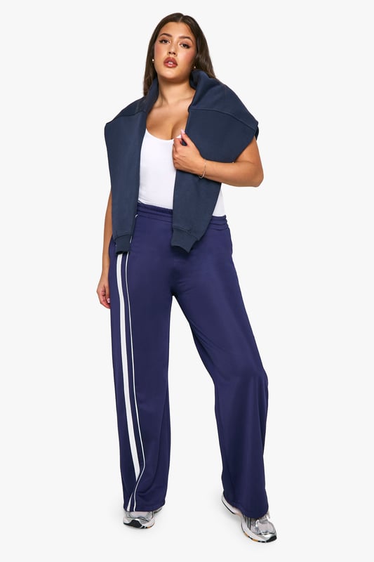 Straight fit joggers for a relaxed silhouette
        Side stripes add a sporty, contemporary touch
        Comfortable jersey fabric for all-day wear
        Wide leg design for effortless movement
        Versatile style suitable for various casual occasions
    
    Embrace comfort without compromising on style with these plus-size joggers from Boohoo. The straight fit and wide leg design offer a flattering silhouette while ensuring unrestricted movement. The side stripes lend a trendy, athletic-inspired look that's perfect for the fashion-forward woman. Pair these versatile joggers with a fitted white tee and trainers for a laid-back daytime ensemble, or dress them up with a cropped jacket and statement jewellery for a chic evening out with friends. The soft jersey fabric makes these joggers ideal for lounging at home, running errands, or attending casual family gatherings. For a coordinated look, match with the hoodie as shown in the image, completing an outfit that's both cosy and stylish. These joggers are a must-have addition to your wardrobe, offering endless styling possibilities for the modern, confident woman who values both comfort and fashion.