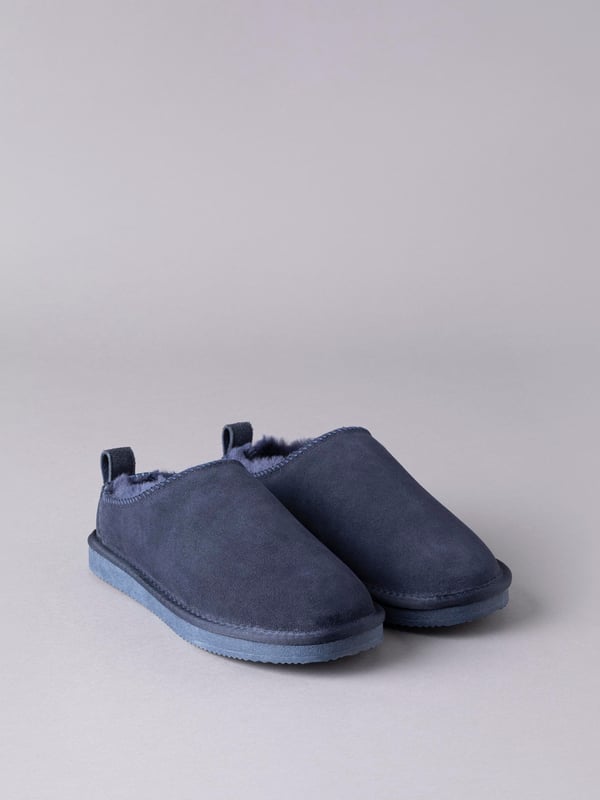 Our sheepskin clog slippers are just the remedy against chilly toes in the colder months. Crafted from 100% natural sheepskin with cushioned air-pocket insole, you won't believe how warm and comfy they are until you try them. Featuring a hard-wearing rubber sole and a tab with branded stud for ease of getting them on and off (although you'll never want to be out of them!), these clog slippers really are a winter essential. The natural fluffiness of the sheepskin will make your slippers feel slightly small at first but this will soon mould comfortably to your foot. If the length feels fine, you have the right size. If you can feel your toe is touching the front of the slipper, it is too small, you'll need to size up. We recommend you size up if you are between sizes.