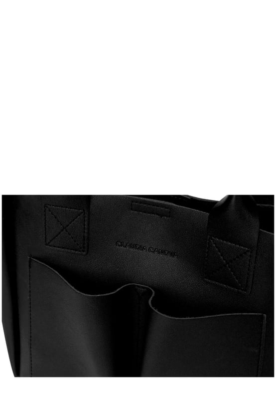 This dreamy mini grab bag is perfect for adding a contemporary look to your outfit. The soft PU exterior and contrast unlined interior gives it a premium finish and the gunmetal hardware adds quality. The subtle Claudia Canova blind debossed logo and intricate stitch detail finishes the look. Inside is a secure zip top pouch, which can be removed by unfastening the snap clasp buttons, perfect to use as a portable makeup bag or to keep valuable items more secure. Features: , soft pu outer, Unlined Interior, Claudia and Canova Blind Deboss Logo, 2 x Short Grab / Tote Handles, Adjustable longer shoulder strap, Magnetic snap claps opening to the main compartment, Removable zip top pouch (Meausure 215W x 152H x 50D), 2 x Quick access slip pockets in front Style Ref: 84608 BLACK