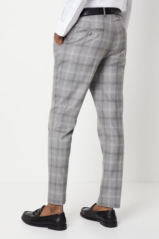 Slim fit tailored trousers with a sleek, tapered silhouette
Crafted from a fine grey check patterned fabric
Flat front styling with slant side pockets
Belt loops to accommodate a smart leather belt
Hem designed to sit neatly on the shoe

Exuding refined sophistication, these slim fit trousers from Burton are the epitome of smart tailoring. Pair them with a crisp shirt and blazer for a polished look at formal occasions or dress them down with a knitted jumper for elevated weekend styling. The slim cut flatters the frame while the grey check pattern adds a touch of classic British flair, making them a versatile choice for the modern gentleman's wardrobe.