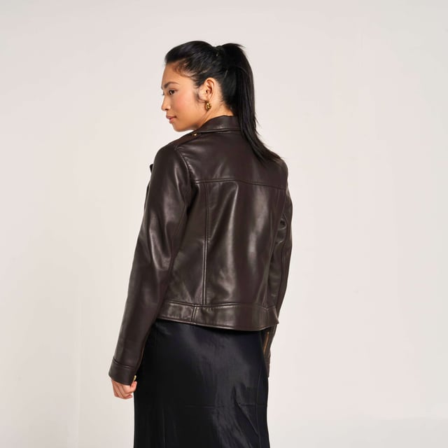Barneys Originals real leather asymmetric biker jacket in a rich chocolate brown, featuring gold trims that beautifully complement the color. Crafted from soft, luxurious leather for a timeless and elegant finish.
