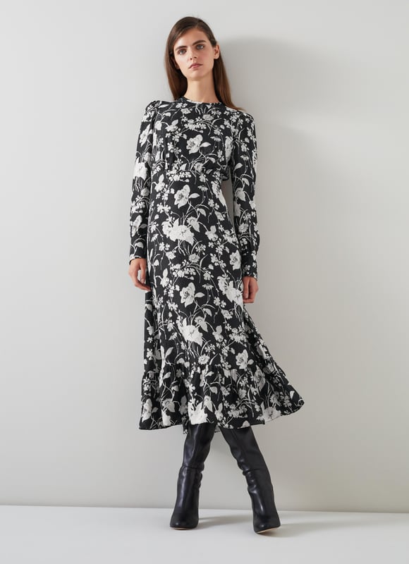 LK Bennett Winona Dresses, Black/Cream Embrace a night of elegance with the Winona mono meadow print jacquard dress. This black silk mix beauty features a sophisticated floral design, complete with back buttons, a zip, and a timeless crew neck. Pair it with your favourite heels or statement jewellery for a truly captivating look.