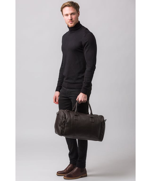 Crafted from natural leather with a supple and ultra-soft feel, the 'Ocean' holdall from Cultured London is the perfect bag for a when travel is on the agenda. The zip-over top secures the main compartment, concealing the 100% natural cotton lining. Two outer zipped pockets provide extra storage solutions, complemented by metal fittings. Comes with matching leather grab handles and an adjustable strap with a drop length of 70cm. Finished with the contemporary embossed Cultured London logo.