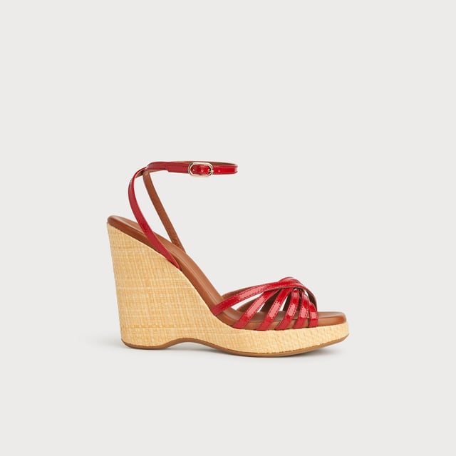 With a hint of Seventies' playfulness, our Solange wedges balance height and comfort. Crafted in Italy from red patent leather, they have a crossover multi-strap design, a delicate ankle strap and a beige raffia 110mm wedge sole. Perfect with summer's cool cotton and linen skirts and dresses, they're also great with wide leg trousers.